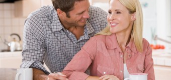 Man and woman in a house kitchen smiling