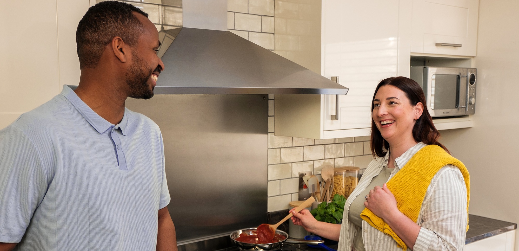 Couple at home cooking on gas